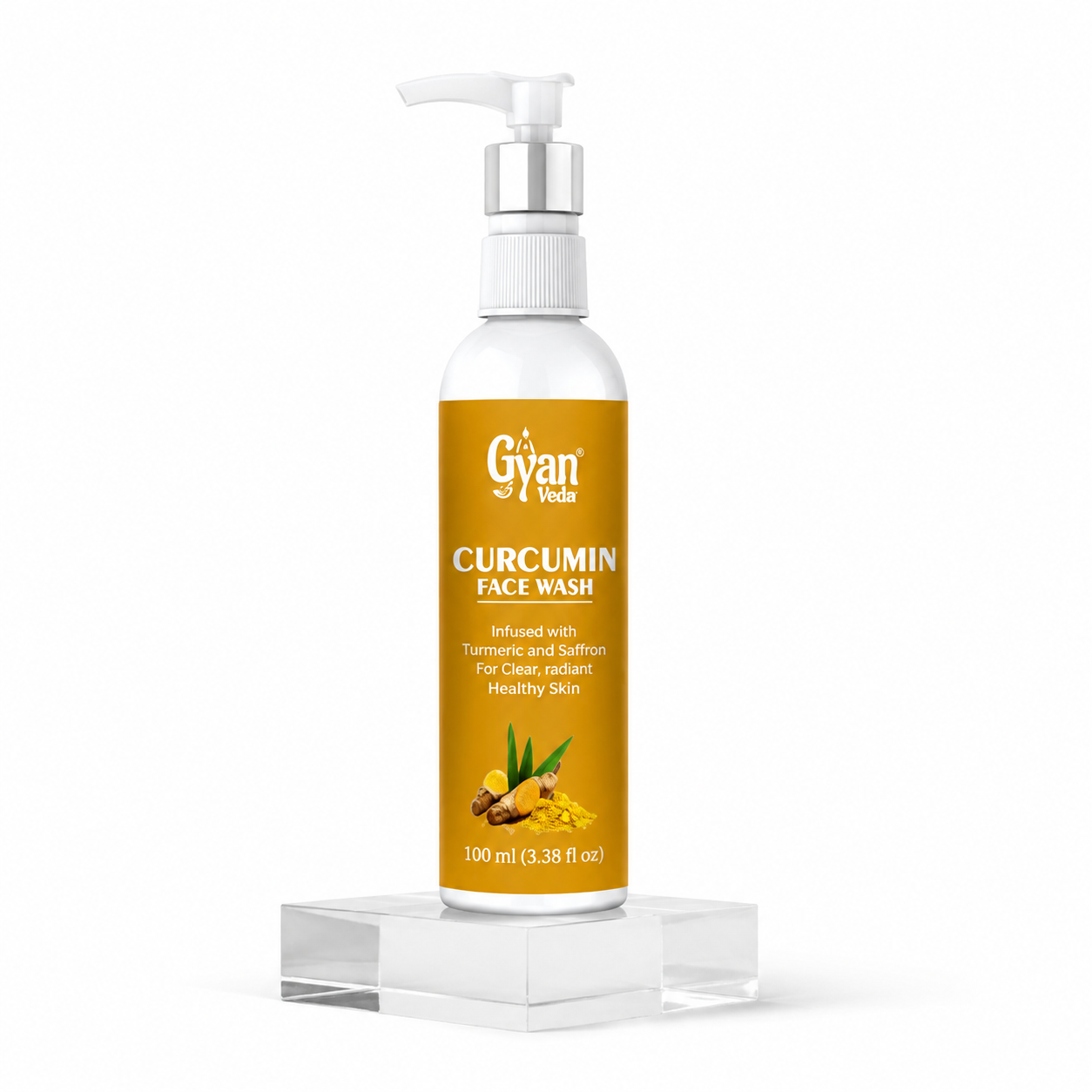 A 100 ml bottle of Gyan & Nada Curcumin Face Wash, featuring a white bottle with a silver pump and a golden-yellow label, displayed on a clear acrylic block against a white background.