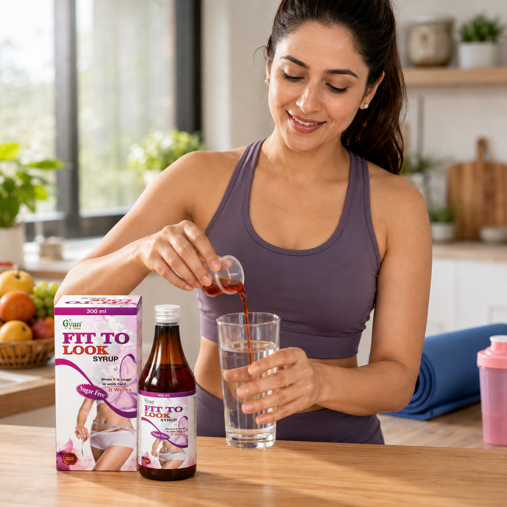 A woman in a purple athletic tank top is shown in a bright kitchen setting, pouring a dark red liquid from a small glass container into a clear glass. On the wooden table next to her are a bottle of Fit To Look Syrup and its pink and white packaging box.