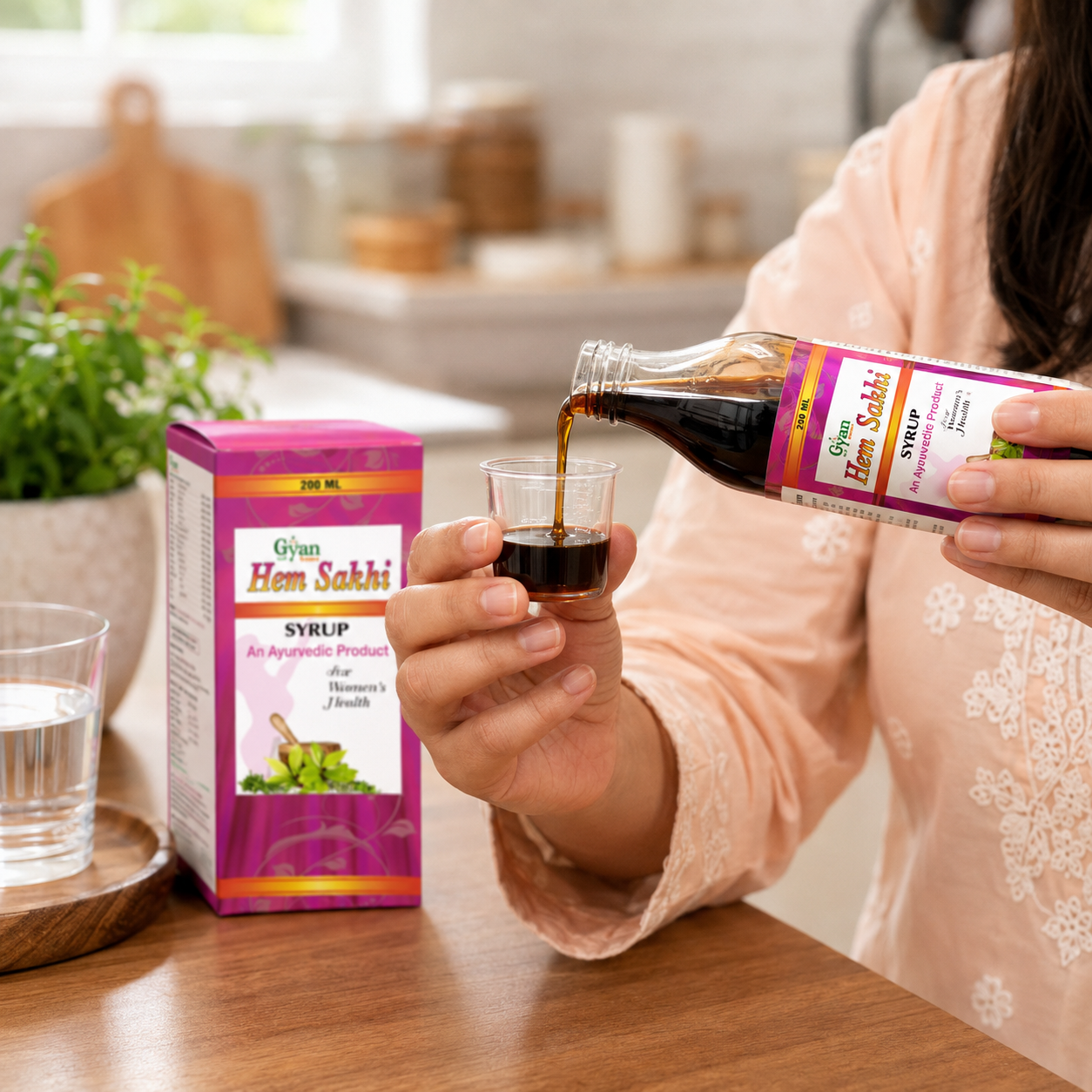 Woman pouring a dose of Gyan Hem Sakhi Ayurvedic Syrup into a measuring cup.